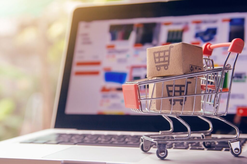 a miniature grocery cart on top of a laptop computer