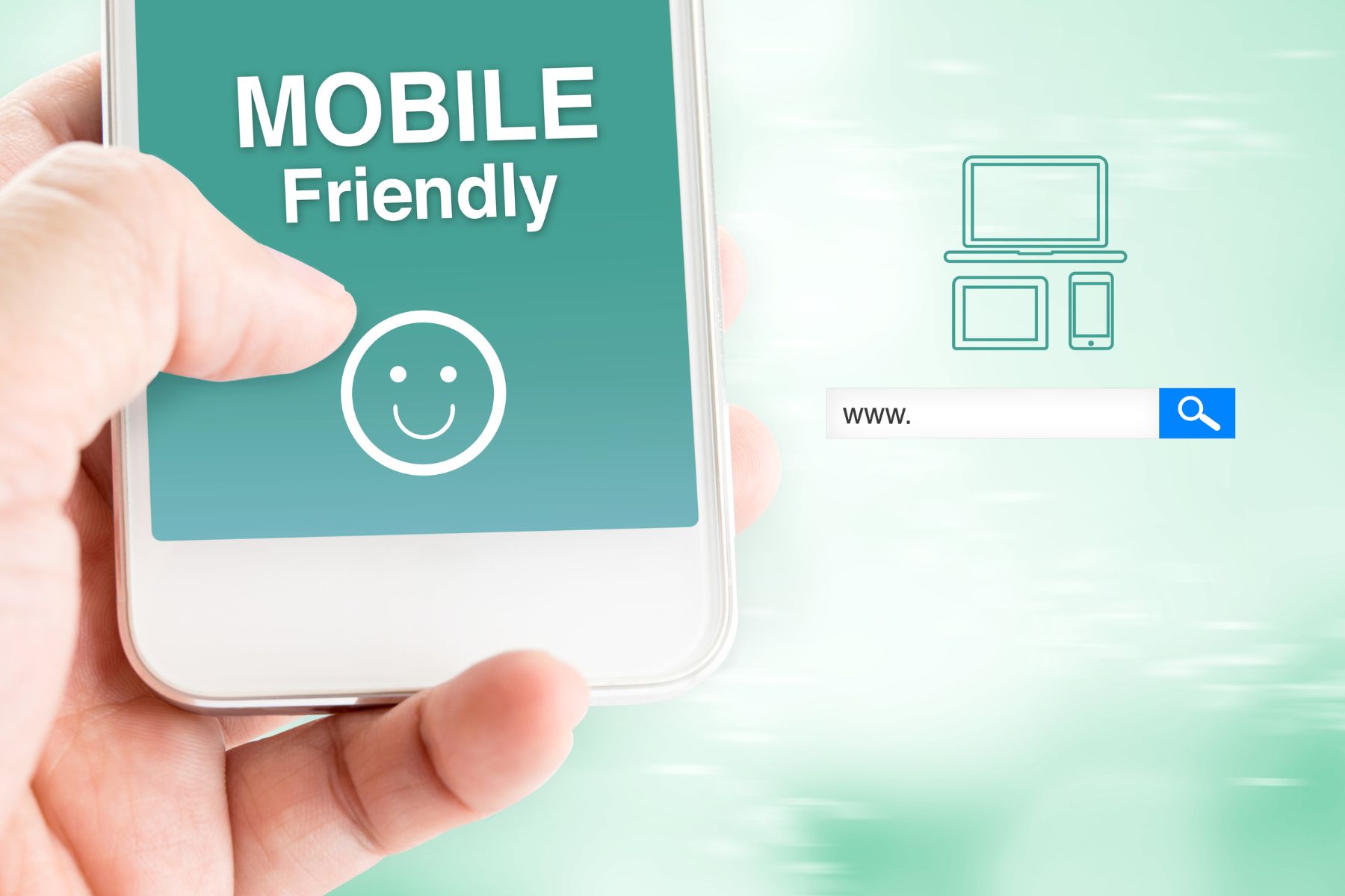 a hand holding a mobile phone with MOBILE FRIENDLY words on the screen and a smiley
